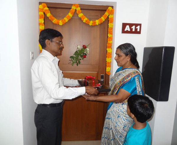 Keys being handed over to Mrs. Laksmi of apartment A 11 