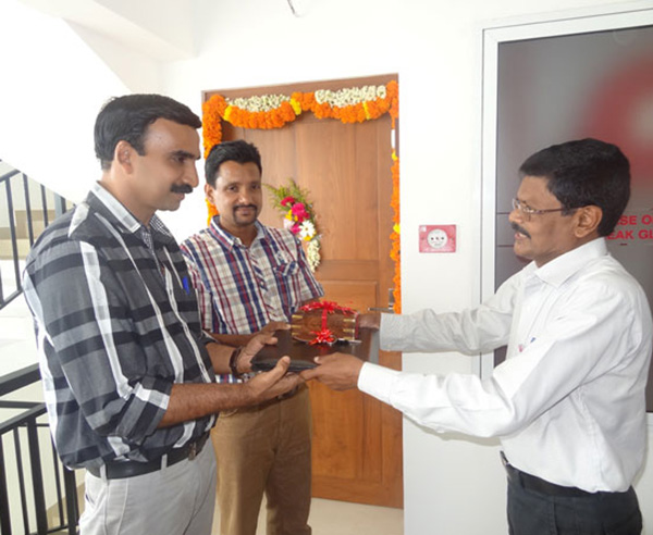 Keys being handed over to Mr. Vinod Kumar & Mr. Santhosh Kumar of apartment B 9