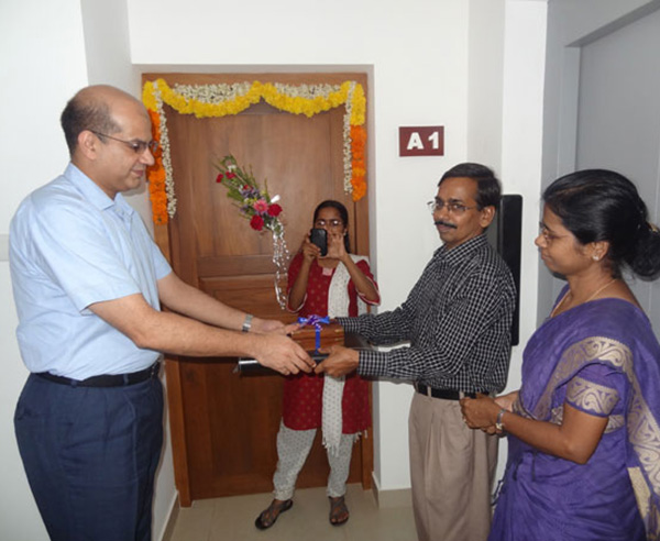 Keys being handed over to Dr. Vasudevan and Dr. Anandavally , apartment A 1