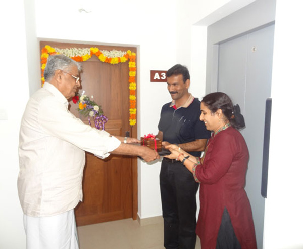 Keys being handed over to Mr. & Mrs. Pramod Kumar Pooleri  of apartment no A 3