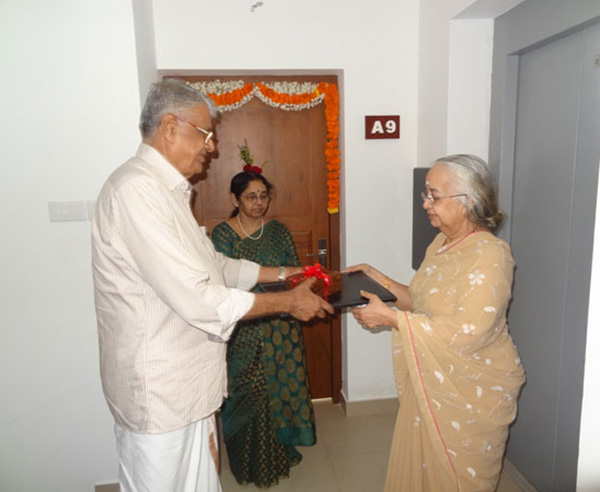 Keys being handed over by  Mr. C  V. Musthafa (Partner - Crescent Builders) to Ms. Lakshmi on behalf of Dr. Srikumar & Dr. Preetha of apartment A 9