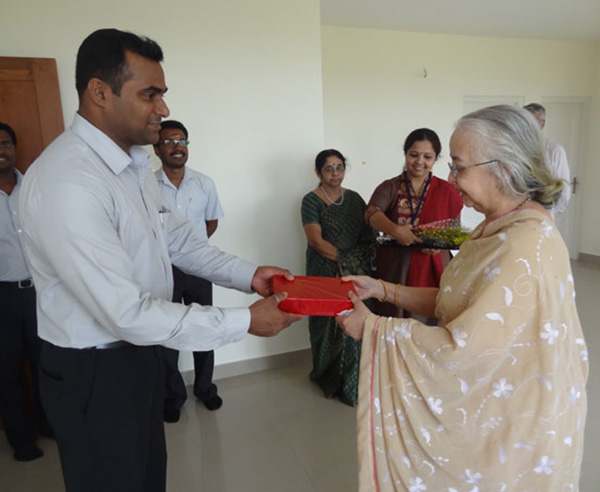 Ms. Lakshmi of apartment no A 9 in Crescent Mansa being greeted by our GM Sales Mr.Savin.