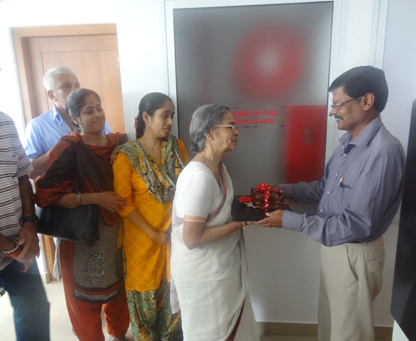 Keys being handed over to Ms. Thankam of apartment C 7