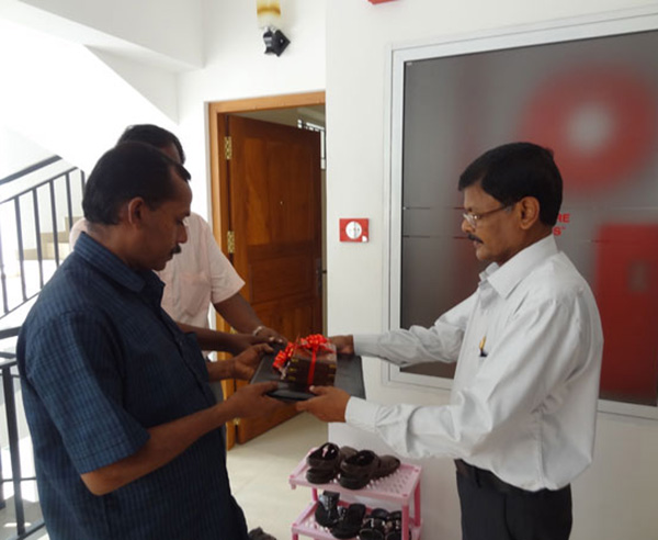 Keys being handed over by GM - Projects Mr. Sasidharan to Mr. John on behalf of Mr. Jose Philip of apartment C 1