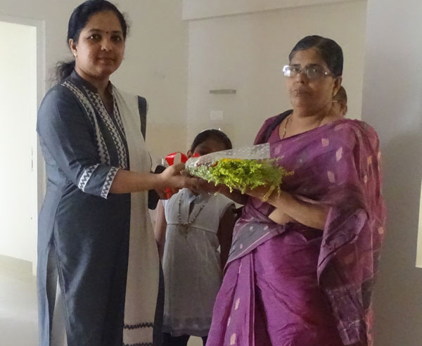 Our Relationship Officer greeting Ms. Sharada of apartment A 3 in Crescent Aster during handing over ceremony.