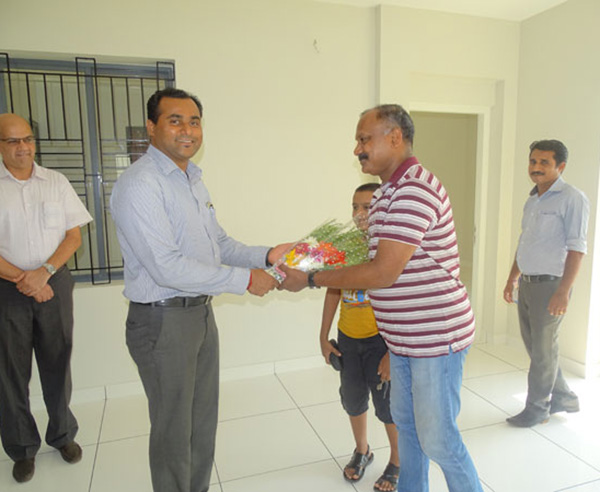 Our General Manager - Sales & Marketing greeting Mr.Rajesh T  Krishnan of apartment B 8 Crescent Aster during handing over ceremony.