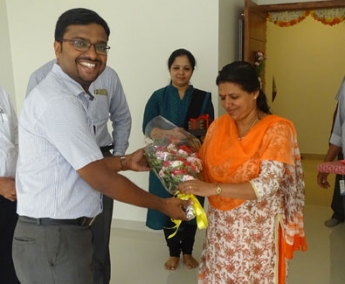 Our Project Engineer - Jijo John greeting Ms. Ammu Narayanan of apartment B 4 Crescent tulip during handing over ceremony.