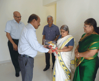 Our G M Administration - Rajan greeting Ms.Chandramathyamma of apartment no.B 5 in Crescent Zinnia during handing over ceremony.