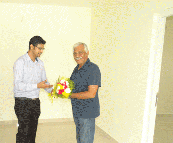 Our AGM Projects - Jeswint Clement greeting Mr.M T Ramakrishnan of apartment no.C 6 & B 3 in Crescent Zinnia during handing over ceremony.