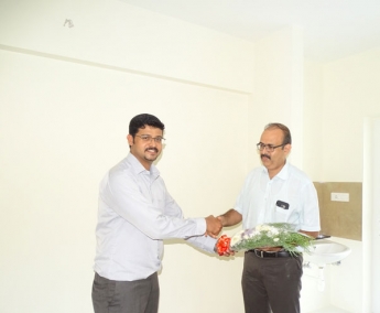 Our A G M Projects - Jeswint Clement greeting Mr. Paul Verghese of apartment no.B 4 in Crescent Zinnia during handing over ceremony.