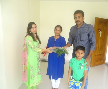 Our Asst.Manager Relationship & Marketing - Shilpa Madathil greeting Mr. Dinesh Kumar P.K of apartment no. A 4 in Crescent Zinnia during handing over ceremony.